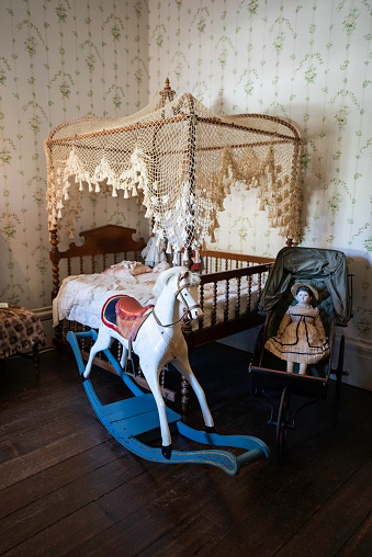 Children's bedroom at Rosedown Plantation with bed, antique rocking horse and doll, built in 1834 by Daniel Turnbull one of America's wealthiest families, St. Francisville, Louisiana, USA