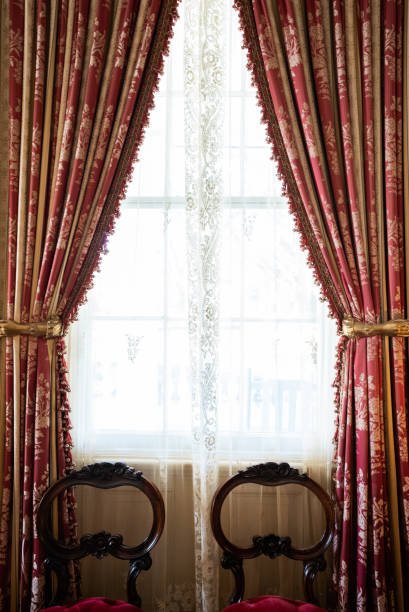 Original window covering with gold painted arm holding back the curtained fabric at Rosedown Plantation, built in 1834 by Daniel Turnbull one of America's wealthiest families, St. Francisville, Louisiana, USA