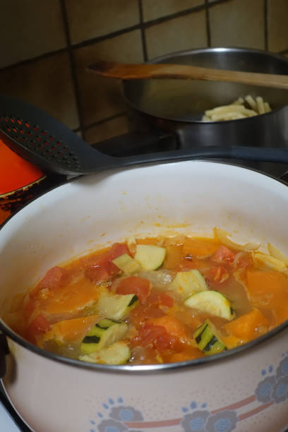 istock Varied vegetable and pumpkin soup being cooked in a pot 1348173212