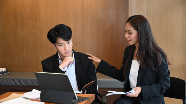 istock Two business colleagues discussing for new project planning in office. 1348175020