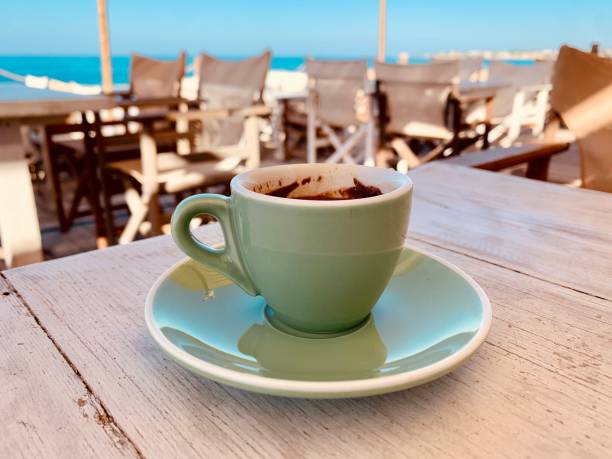 istock Cup of coffee on wooden table top view 1348179507