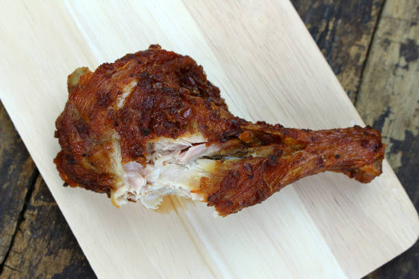 istock Grilled chicken drumstick on wooden background 1348182223