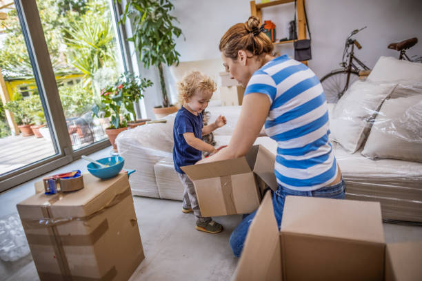 istock Family unpacking cardboard boxes at new home 1348183880