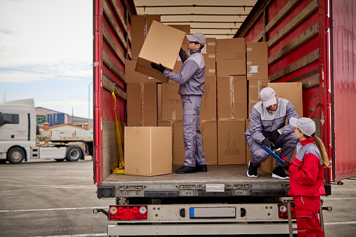 Woman receiving delivery, signing a clipboard