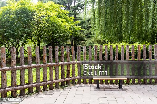 istock Green tree fences and benches in the park 1348185063