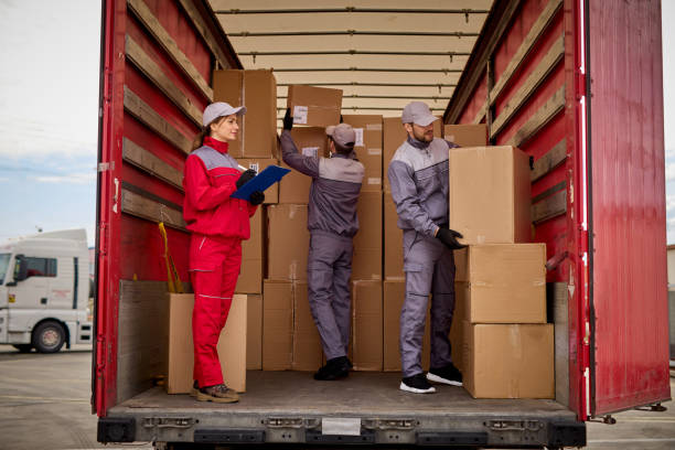 Woman receiving delivery, signing a clipboard stock photo