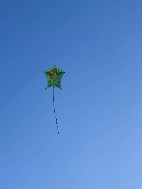 istock Children's kite in the blue sky 1348186651