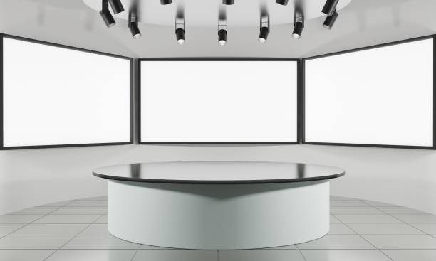 istock white table on stand with blue light background in a news studio room.3d rendering. 1348186699