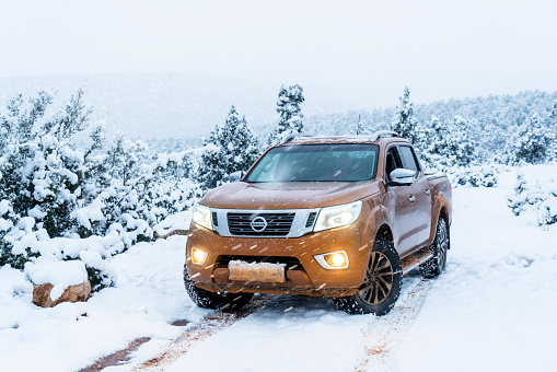 Antalya, Turkey - December 24th, 2017: Nissan NP300 Navara stopped on forest road under a heavy snow. The newest generation of Navara was debut in 2015 on the market. The Navara is powered by 2,3-litre diesel engine and 190 HP