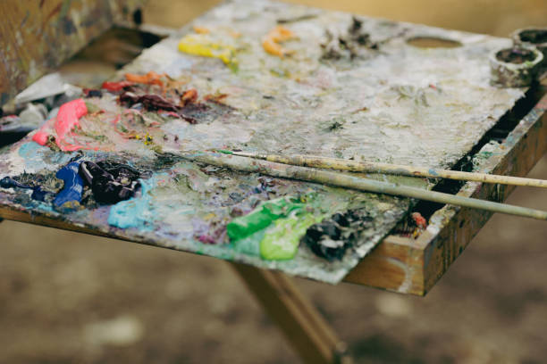 istock Shallow depth of field (selective focus) image with a painter color palette while painting a landscape on a sunny autumn day. 1348188768