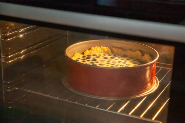 Process of making rustic shortbread pie with blueberries in sour cream filling in a baking dish in the oven.