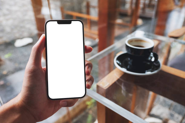 istock a man holding mobile phone with blank white screen in cafe 1348192980