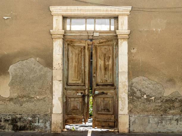 istock Obsolete door in abandoned house wall 1348193349