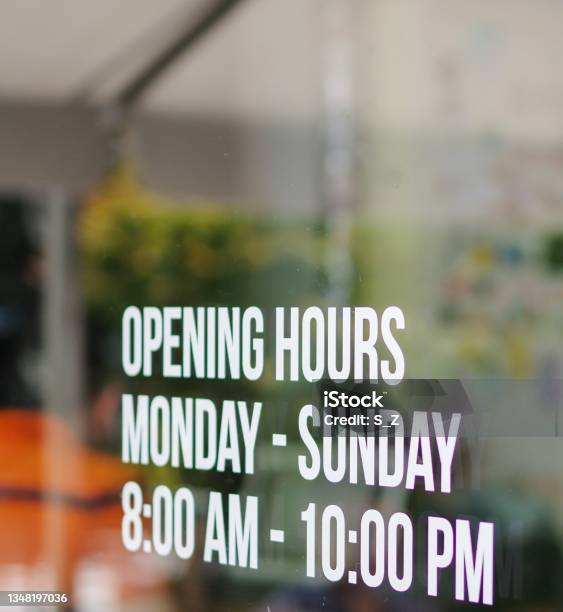 Opening Hours Shop Window White Decal Sticker Monday To Sunday 8am To 10pm Stock Photo - Download Image Now