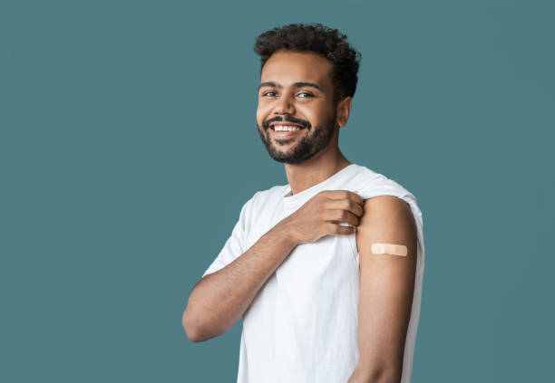 istock Man showing his vaccinated arm with plaster, got COVID-19 vaccine 1348197197