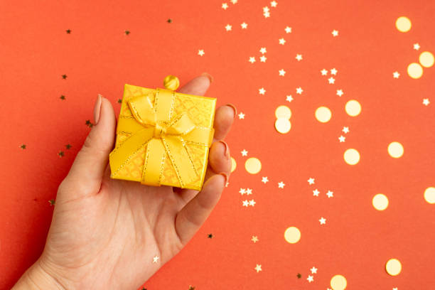 istock A New Year 's gift in a woman 's hand . A Christmas present. Copy space. An article about choosing a gift. 1348198221