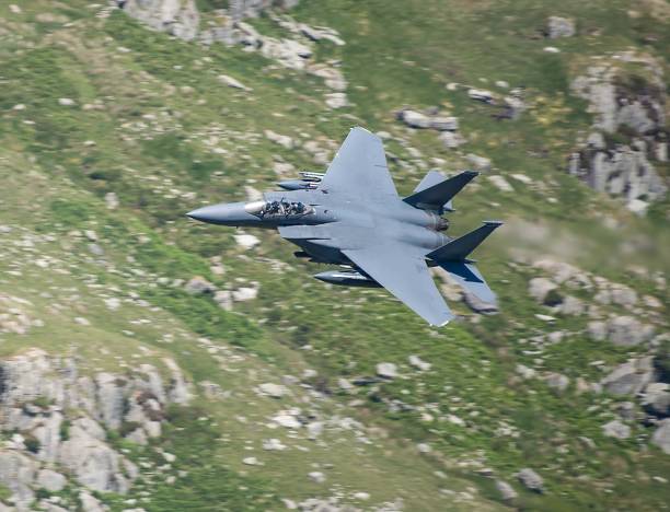 istock Military Aircraft in Flight. RAF F-15 Strike Eagle Low Level Attack and Evasion Training North Wales Mountains, UK 1348200309