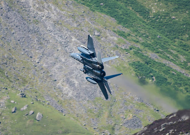 istock Military Aircraft in Flight. RAF F-15 Strike Eagle Low Level Attack and Evasion Training North Wales Mountains, UK 1348200347
