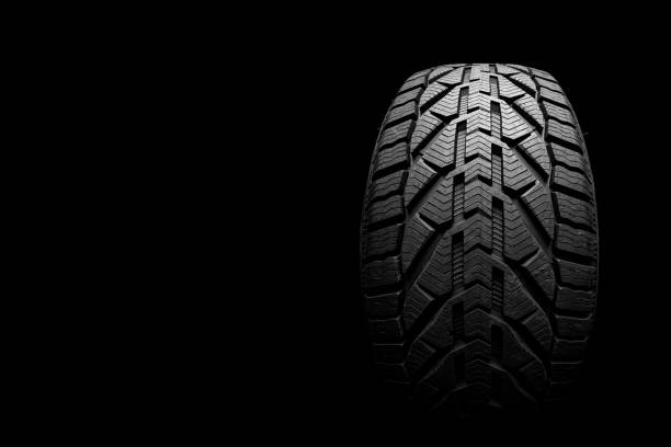 istock black isolation rubber tire, on the black backgrounds 1348200439