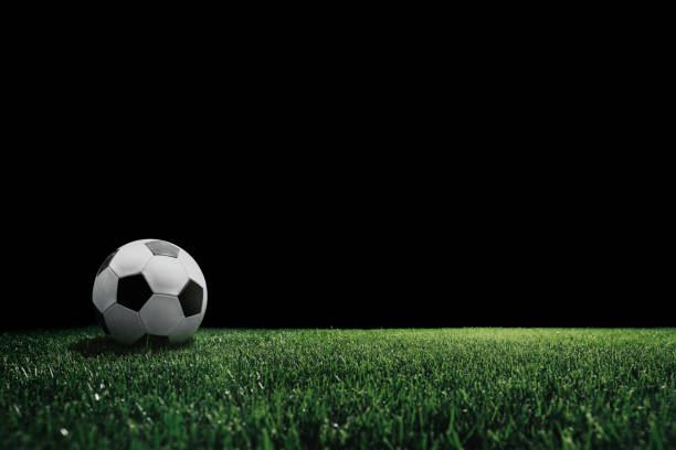istock football field with glowing spotlight 1348200444