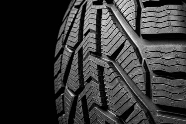 istock black isolation rubber tire, on the black backgrounds 1348201095