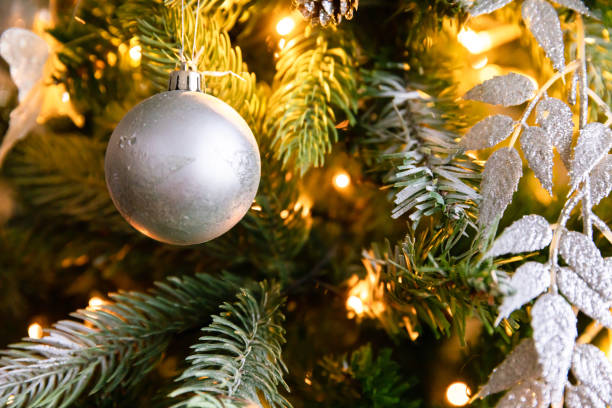 istock Classic Christmas decorated New year tree. Christmas tree with wite and silver decorations, ornaments toy and ball. Modern classical style interior design apartment. Christmas eve at home 1348201168