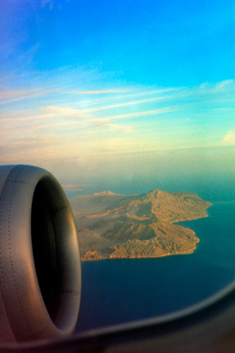 View through the airplane window on the flight over the Mediterranean Sea on vacation to Egypt. Please note that the image was scanned from an over thirty years old negative.