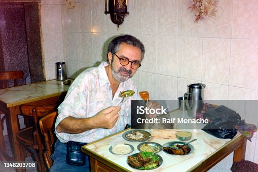 istock The nineties. Typical Egyptian breakfast in a local food restaurant at the famous Khan el Khalili bazaar. Old Cairo, Egypt 1991. 1348203708