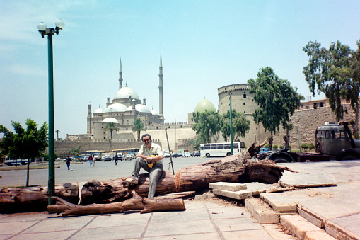 Tourist with a video recorder at the front of the Mohamed Ali Mosque and the Citadel of Cairo.
Please note that the image was scanned from an over thirty years old negative.