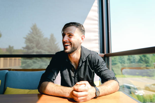 istock Male ecologist sitting at office on sofa with trees in background 1348204954