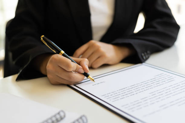Close-up business woman writing contract signing agreement. stock photo