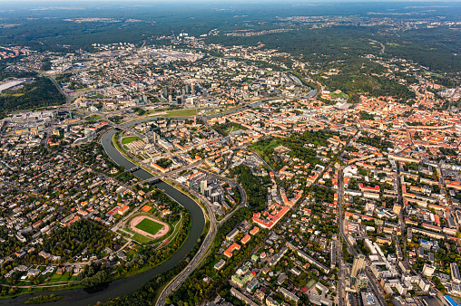 Scenic view on central part of Vilnius capital of Lithuania from hot air balloon. Neris river flowing curve through the city. Downtown district cityscape view from the sky