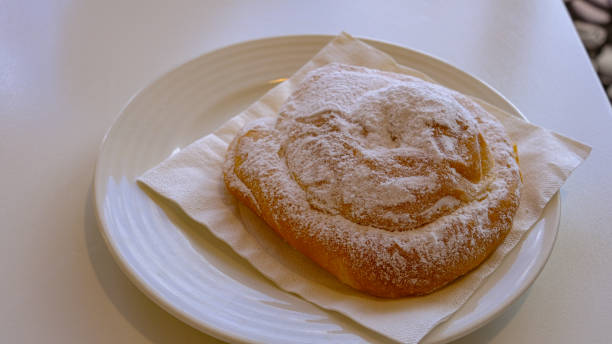 istock typical dessert of Menorca: ensaimada. on white plate and white table 1348211160