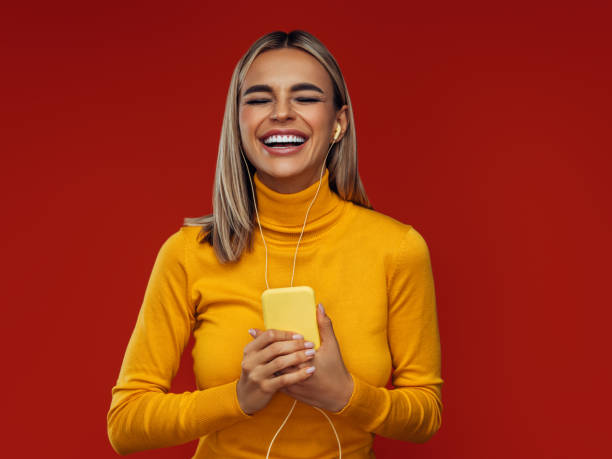 istock Beautiful emotional woman using smart phone 1348211411