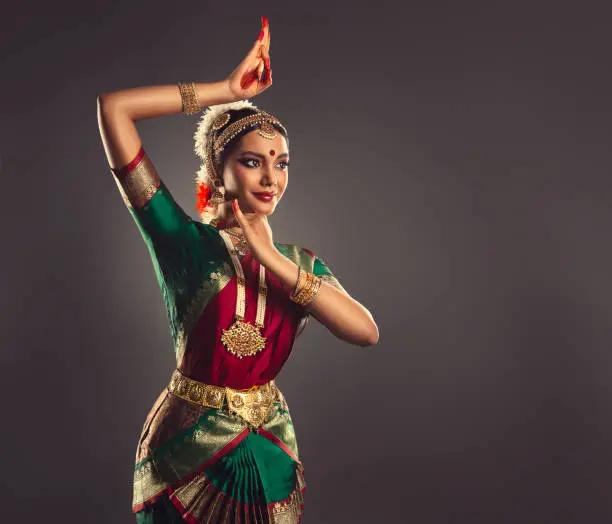 Photo of Beautiful woman dressed in a traditional Indian dance suit is shows beauty of classic dance. Indian culture.