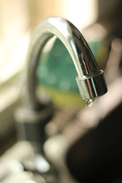 istock Blurred Kitchen Faucet at the sink selective focus with water drop from it under concept of water saving or washing carefully of water conservation awareness at kitchen in Thailand 1348212850