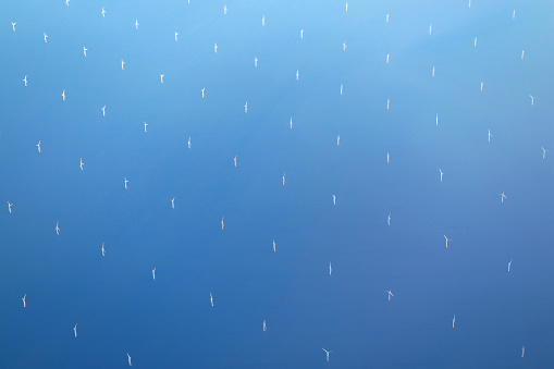 Bird's eye view of the offshore wind farm of United Kingdom seen from plane during flight