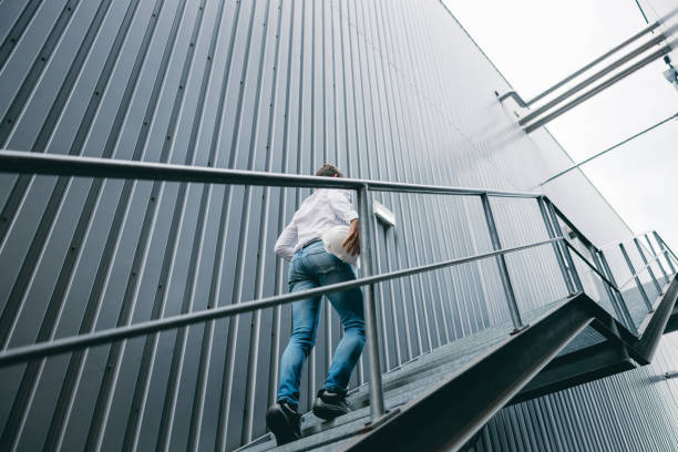 istock Engineer walking upstairs on steel staircase 1348217266