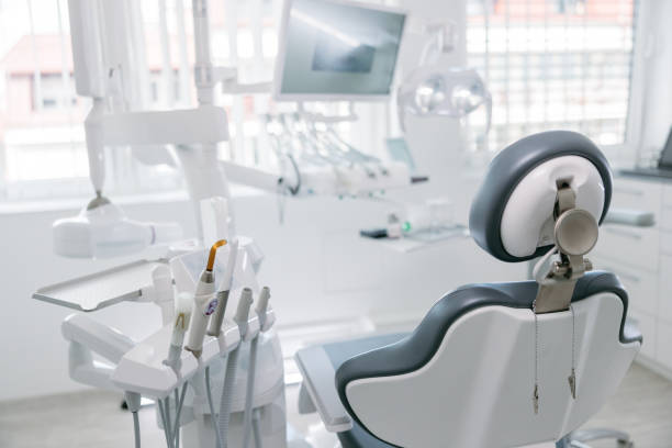 taladros dentales modernos y silla vacía en el consultorio del dentista - silla de dentista fotografías e imágenes de stock