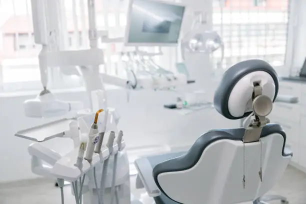 Modern dental drills and empty chair in empty dentist's office