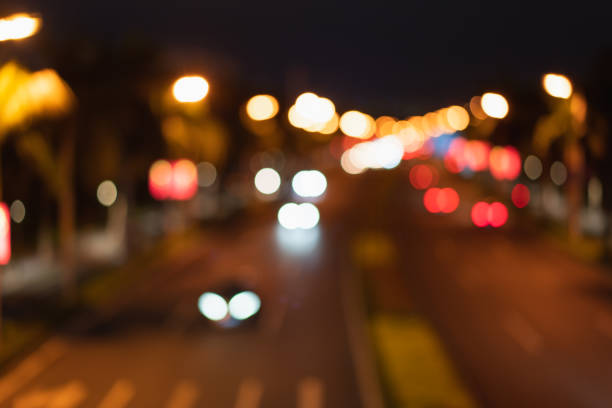 Abstract blurry defocused city lights, circular and oval light shapes, looking down on the blurry effect of city night lights