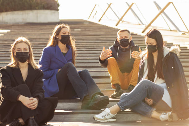 istock Young people taking chat with protective face masks during pandemic outbreak 1348219865