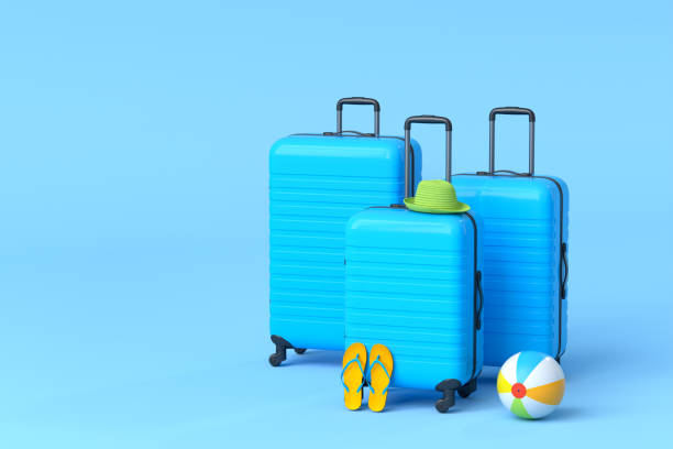 istock Suitcase with beach ball and flip flops on blue background. 1348223686