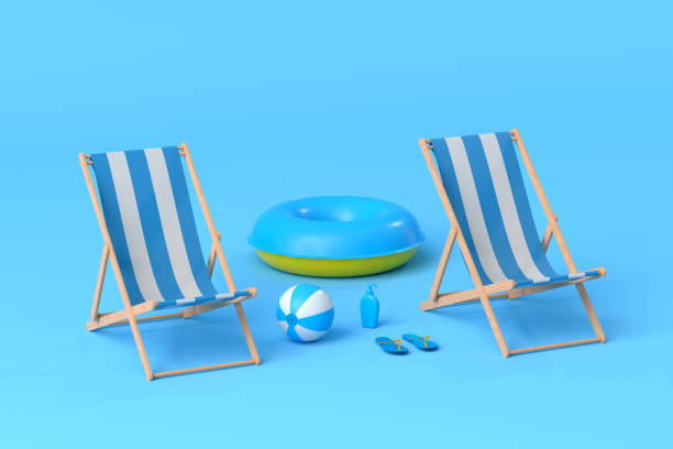 istock Beach chair with inflatable ring and beach ball on blue background. 1348223866