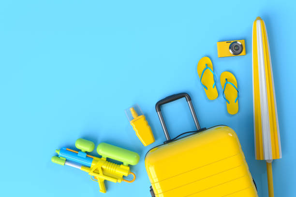 istock Colorful suitcase or baggage with beach accessories on blue background. 1348224938
