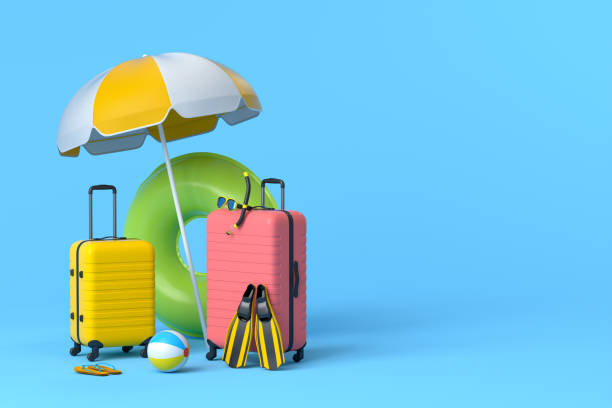 istock Suitcase with beach umbrella and inflatable ring on blue background. 1348225380