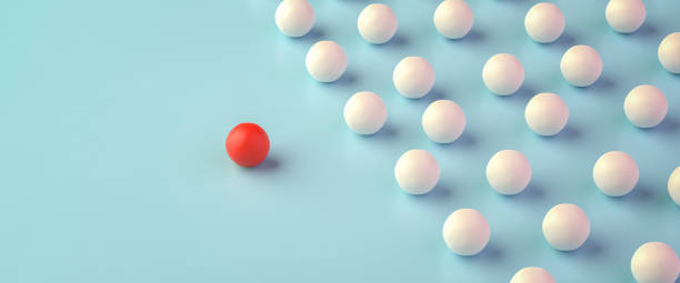 istock Leadership Concept: A group of white spheres with one sphere in red leading the group. Web banner format 1348225475