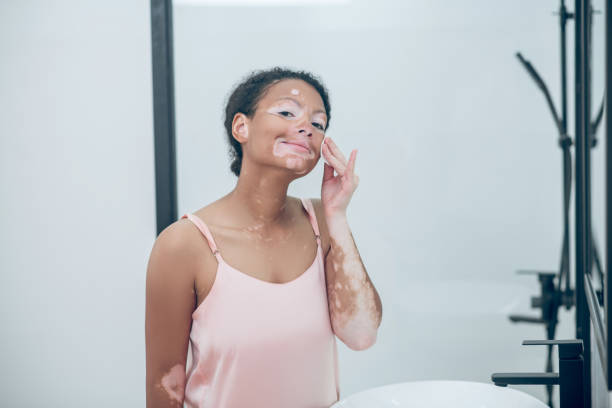 istock A pretty young woman cleansing her face with a sponge 1348226998