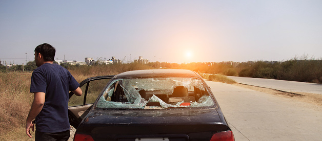 Car with the broken windshield during road accident outdoors.