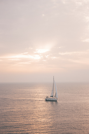 Beautiful landscape overlooking the sea at sunset where a sailing boat sailing in Croatia.